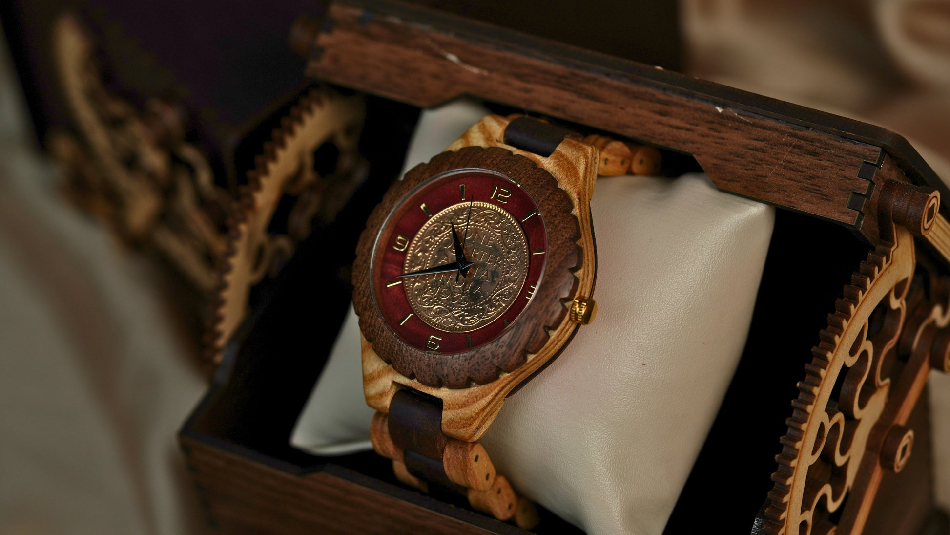 Wooden watch with a red face in a decorative wooden box
