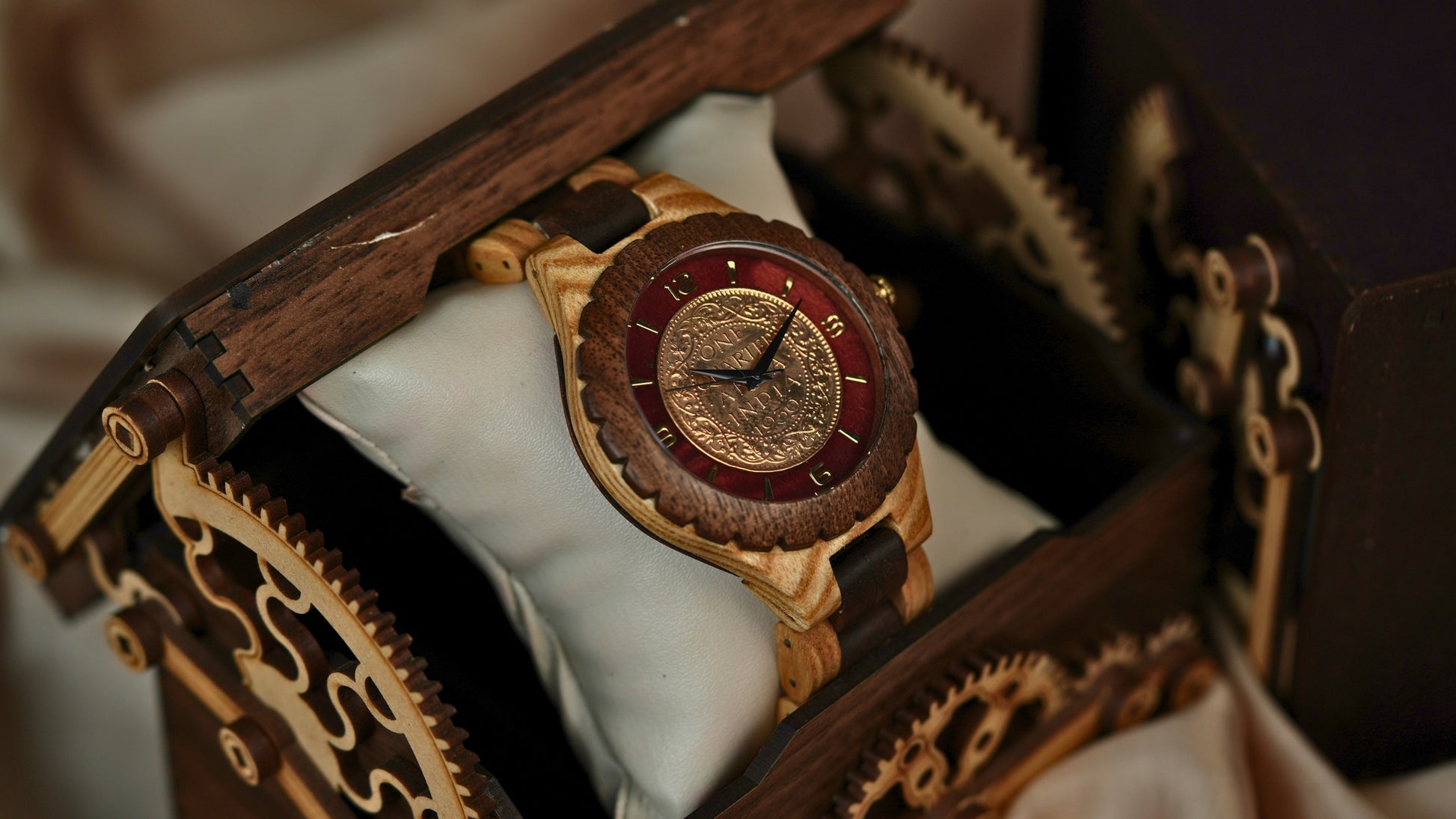 Vintage-style watch with intricate design in a wooden box